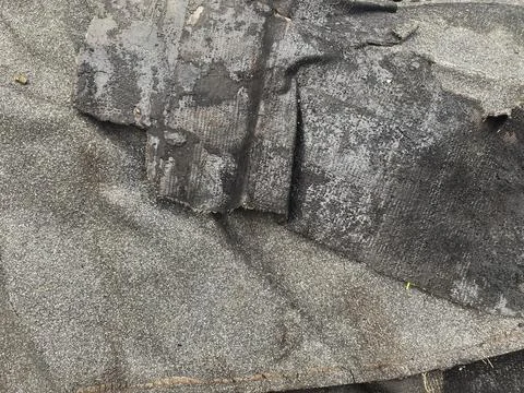 Old roofing material lies on the ground during a renovation project Stock Photos