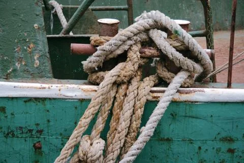 Old ropes on the dock. close up Stock Photos