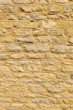 Old rough cut stone wall background showing natural texture, construction, .. Stock Photos