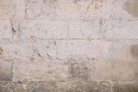 Old rough dirty painted light brick wall surface with cracks Stock Photos
