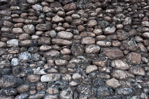 Old rough stone wall background Stock Photos
