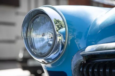 Old round headlight close up view  . front light details blue car . Retro c.. Foto stock