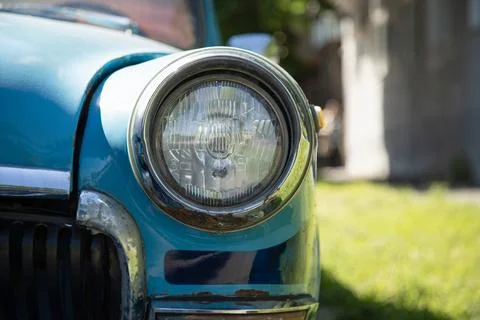 Old round headlight close up view  . front light details blue car Stock Photos