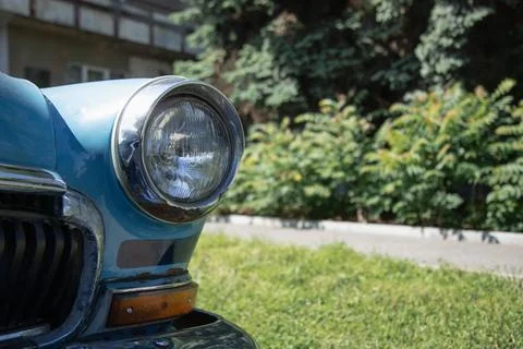 Old round headlight close up view . Copy space . front light details blue car Stock Photos
