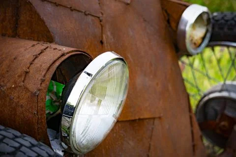 Old round headlights on a rusty car Stock Photos