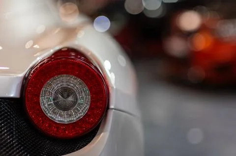 Old round red headlight close up view, front light details white retro car Stock Photos