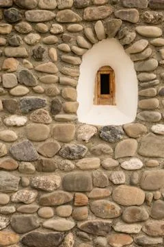 Old round stone wall with small window Stock Photos
