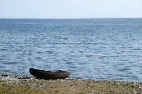 Old rowing boat at seaside Stock Photos