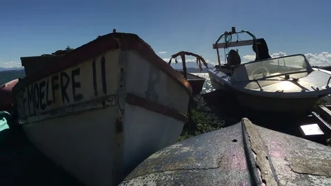 Old rowing boats left on beach in the summer Vídeo Stock 76307380
