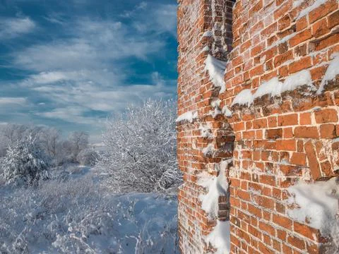 An old ruined brick building with empty windows. Instead of a roof there is a Stock Photos