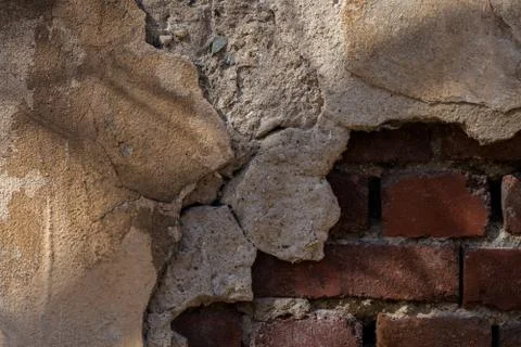 Old ruined brick wall with plaster. Stock Photos