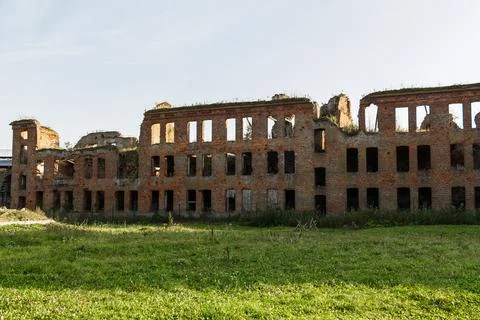 An old ruined building, without windows or doors, made of red bricks. The Stock Photos