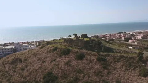 Old ruined castle in small coastal town with sunny seaside Stock Footage 126188341
