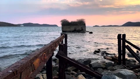 The old ruined pier is washed by light waves. Stock Footage 309729151