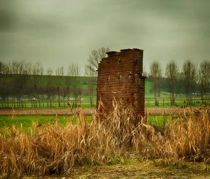 Old ruined wall in the middle of fields Stock Photos