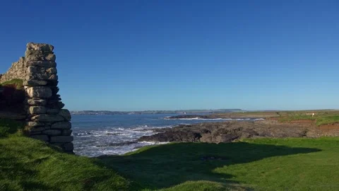 Old Ruins on coast of Hook Head Peninsula rocky outcrops of rock and turbulent Video stock 331750392
