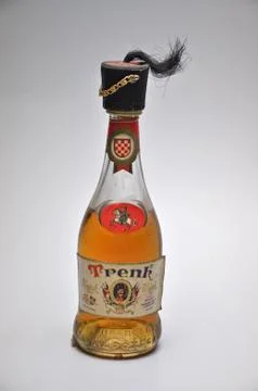 Old rum bottle decorated with an elegant cap Stock Photos
