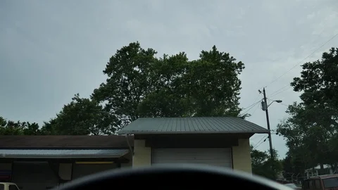 Old run down building with garage (spying from a car) Stock Footage 76452532