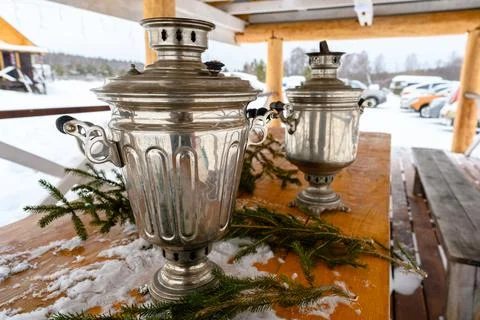 Old Russian rustic table with samovar outdoors. Stock Photos
