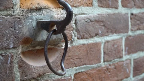 Old rust metal ring on wall with colorful brick background Stock Footage 104979608