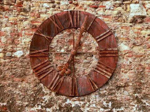 Old rusted clock on the stone wall Stock Photos