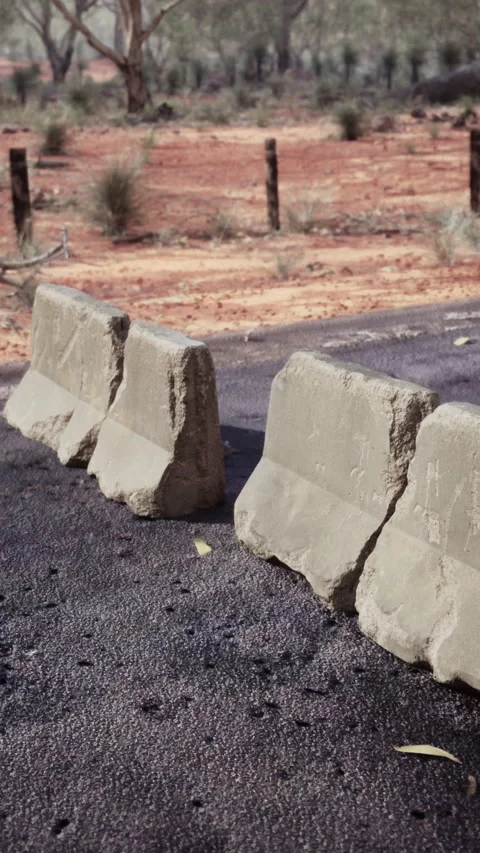 Old rusted concrete road barrier blocks Stock Footage 306123773