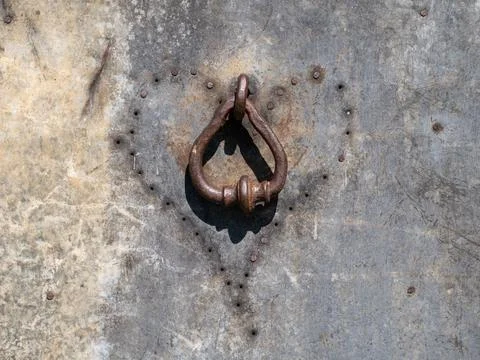 Old rusted door handle with rusting nails surrounded in a heart shape Stock Photos