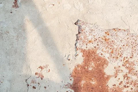 The old rusted surface is partially covered with crumbled whitewash with shad Stock Photos