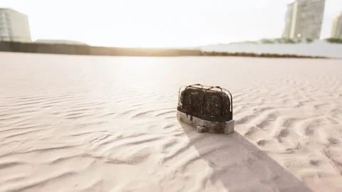 Old rusted trash on the sand beach Stock Footage 237885559