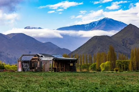 An Old Rustic Barn At The Base Of A Mountain Range Stock Photos