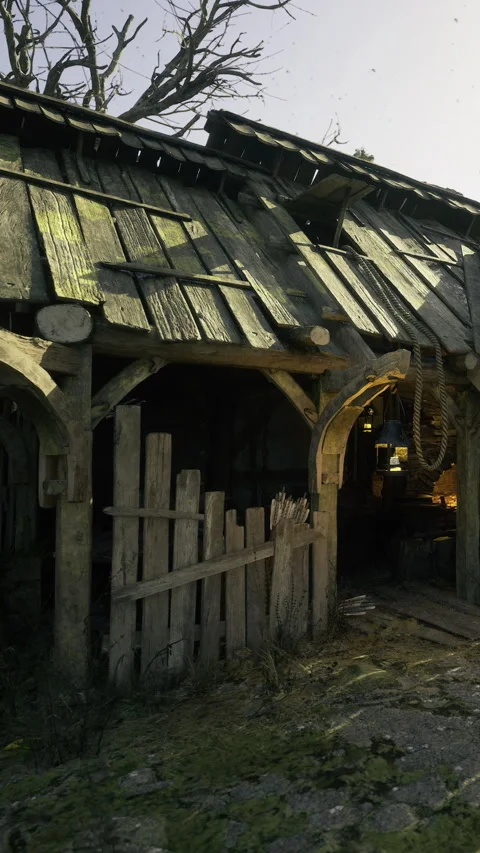 Old rustic barn stands quietly under the warm glow of the evening sun Stock Footage 331818108