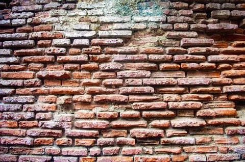 Old rustic brick wall with weathered red bricks and mortar, showcasing a vi.. Stock Photos