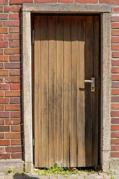 Old Rustic Doorway. Aged Timber Door Set Amongst Mossy Brickwork 스톡 사진