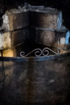 An old, rustic fireplace with dirty, rough bricks Stock Photos
