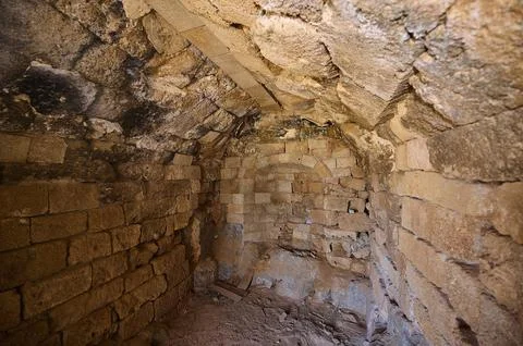 Old, rustic interior with stone walls and structural details, tomb of Cleovoulos Stock Photos