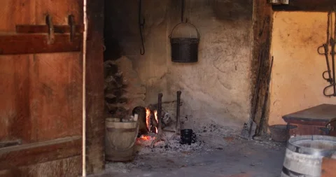Old rustic kitchen with fire burning in a large open hearth Video stock 151568048