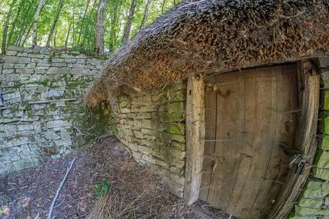 An old, rustic metal structure in a weathered state sits in a forest or par.. Stock Photos
