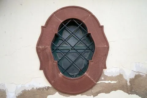 Old, rustic porthole style window in the town of Silves, Portugal. Traditonal Stock Photos