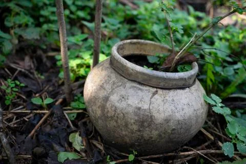 Old rustic pot stands on the ground Stock Photos