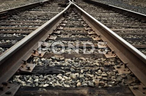 Old rustic railroad track splitting lanes Stock Photos