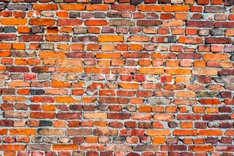 Old, rustic red corroded and damaged brick wall Foto stock