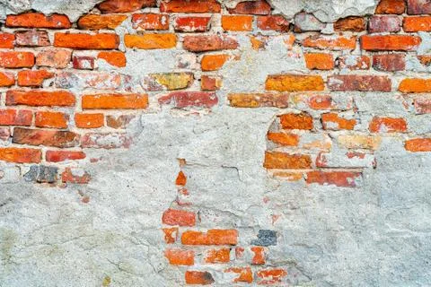 Old, rustic red corroded and damaged brick wall Foto stock