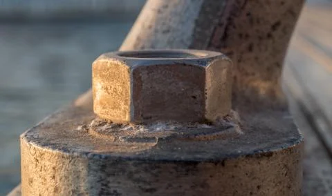 Old rustic screw-bolt on a bollard maritime dock Stock Photos