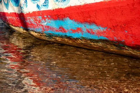 Old rustic ship paint on seaside with water reflection Stock Photos