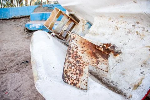 Old rustic Ship's steering fin atached to plastic white old boat . Stock Photos