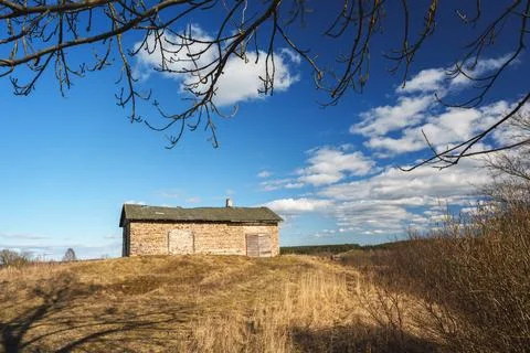 Old Rustic Stone Building on a Hill Under Vibrant Blue Sky Stock Photos