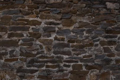 Old Rustic Stone Wall Texture Background with Irregular Masonry Pattern Foto stock