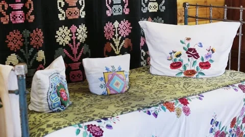Old rustic traditional bed with pillows and beautiful handmade ornaments and Stock Footage 154156120