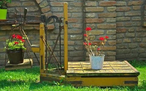 Old rustic vintage scale with flowering plants on it Stock Photos