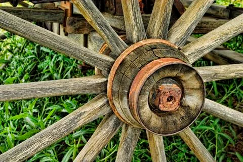 Old rustic wagon wheel abandoned is a field Stock Photos